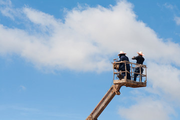 two man stand on crane for record video with dslr camera