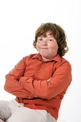 Freckled red-hair boy studio portrait.