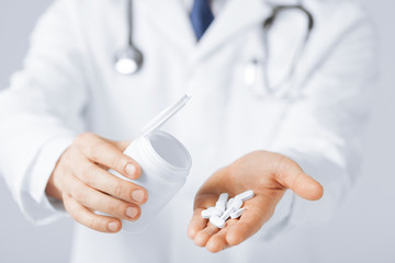 doctor hands holding white pack and pills