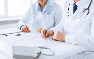 doctor and nurse writing prescription paper