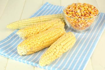 Fresh and dried corn on wooden background