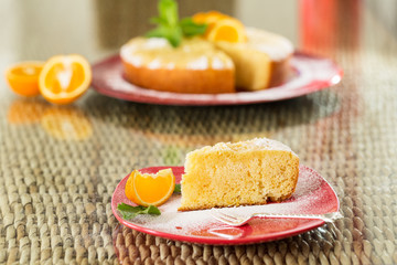 Slice of freshly cooked orange cake on red plate