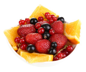 Useful fruit salad of fresh fruits and berries in bowl isolated