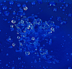 Water drops on blue plastic background