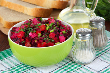 Beet salad in bowl on table close-up