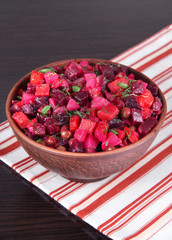 Beet salad in bowl on table close-up