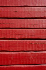 Red painted, hand carved log wall, texture material.