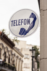 Old phone sign in the street
