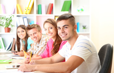 Fototapeta premium Group of young students sitting at the library