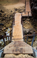 Fototapeta premium Wooden stairs to the rock beach