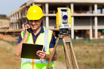 land surveyor talking on walkie talkie