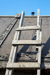 old wooden staircase to roof and into sky