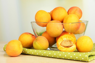 Fresh natural apricot in bowl on table in kitchen