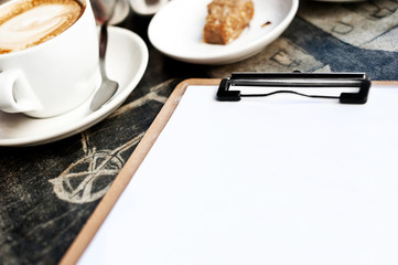 meeting imagery, clipboard with coffee