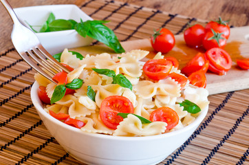 pasta with basil, tomatoes and italian cheese called mozzarella