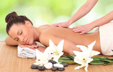 Obraz na płótnie Canvas Beautiful woman enjoying a massage therapy