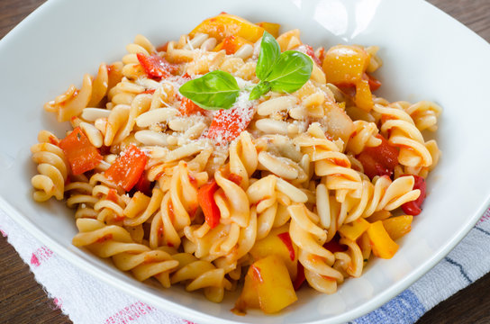 Close up on a dish of fresh pasta with tomato, pepper and cheese