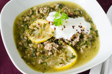 Close up on a dish of lentil stew with minced meat and lemon