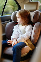 Adorable little girl sitting in car seat © MNStudio