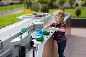 A girl playing with a boat