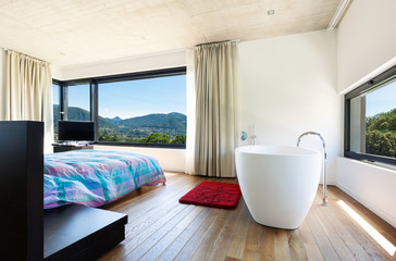Modern villa, interior, bedroom with bathtub