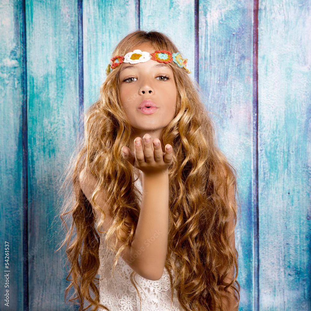 Wall mural Blond hippie children girl blowing mouth with hand