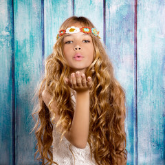 Blond hippie children girl blowing mouth with hand