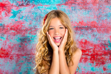 Blond kid girl happy smiling expression hands in face