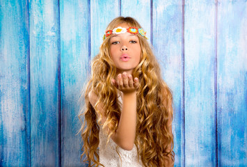 Blond hippie children girl blowing mouth with hand