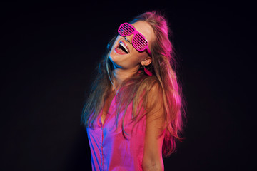 Sexy retro 80s fashion disco girl with long blonde hair and pink