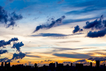 City skyline silhouetted against a blue sunset