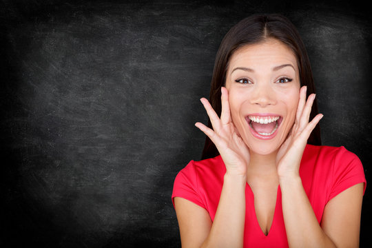 Excited Happy Woman By Blackboard / Chalkboard