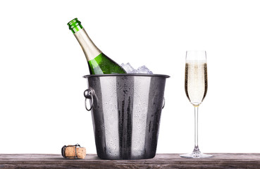 glass and bottle of champagne in ice bucket