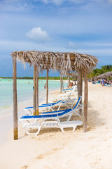 Beach beds and umbrellas at the beach in Cuba