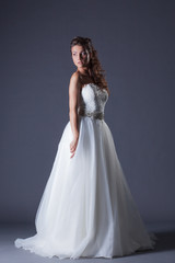 Fototapeta na wymiar Beautiful model posing in elegant wedding dress