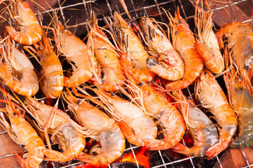 grilled prawns on flaming grill