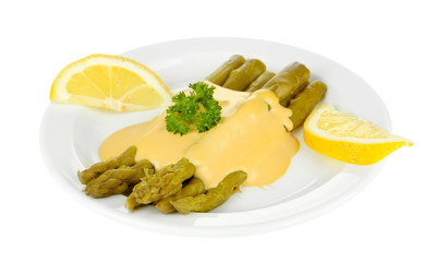 Asparagus with tasty sauce on plate, isolated on white