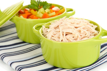 Shredded boiled chicken in green pan close up