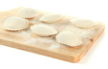 Raw dumplings on wooden desk, isolated on white