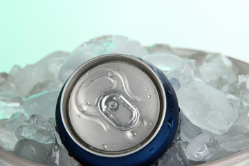 Metal tin with ice on blue background