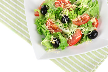 Light salad on plate on napkin  isolated on white