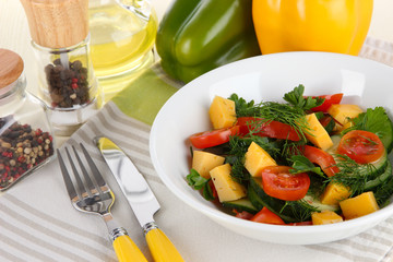 Light salad in plate on wooden table