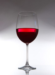 Glass of wine on gray background