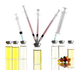 Obraz na płótnie Canvas Medical bottles tablets and syringes isolated on white