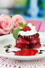 Tasty jelly dessert with fresh berries, on bright background