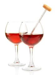 Glasses of wine with thermometer, isolated on white