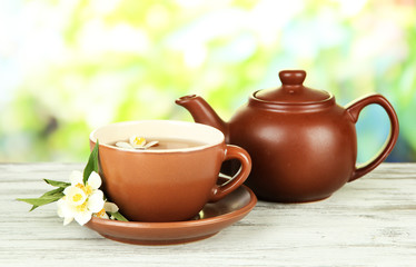 Cup of tea with jasmine, on bright background