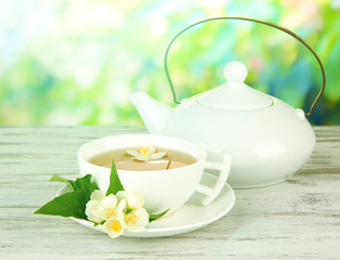Cup of tea with jasmine, on bright background