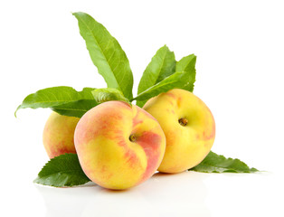 Ripe sweet peaches with leaves, isolated on white