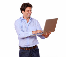 Charming young man working on laptop